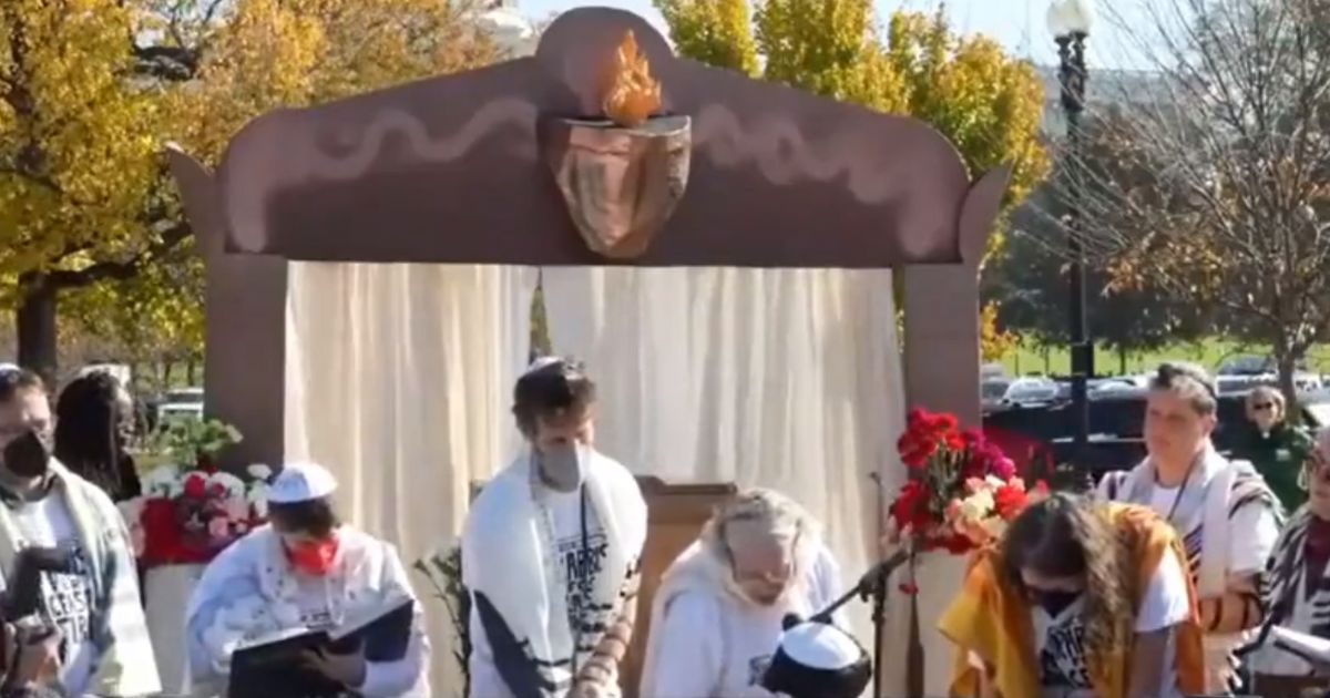 A woman reads from the Torah during a Rabbis for Ceasefire event in Washington on Nov. 13.