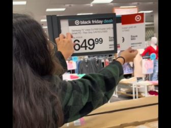 A shopper looks at the prices behind the "Black Friday" labels at Target.