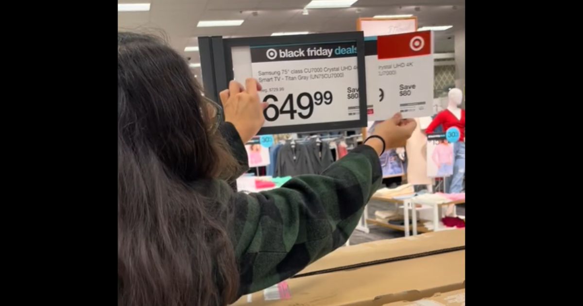 A shopper looks at the prices behind the "Black Friday" labels at Target.