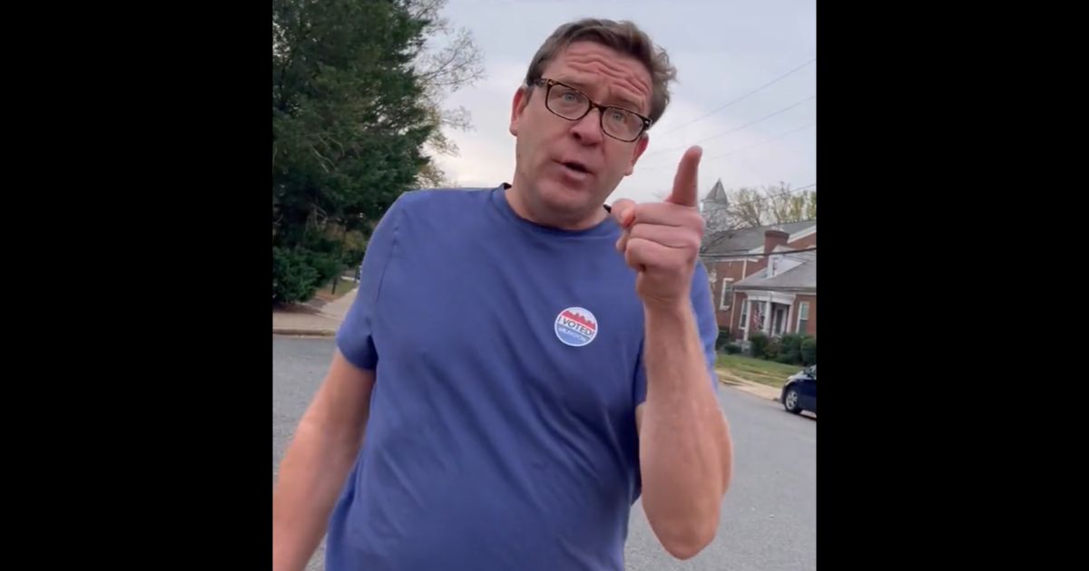 An angry man confronts a Republican poll worker in Arlington, Virginia, on Tuesday.