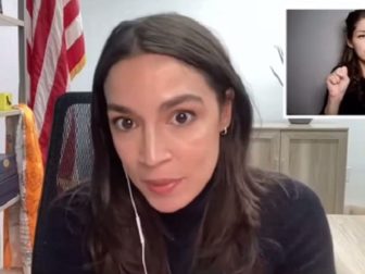 Rep. Alexandria Ocasio-Cortes is pictured in a virtual town-hall meeting on Monday. In the background is a sign language interpreter.