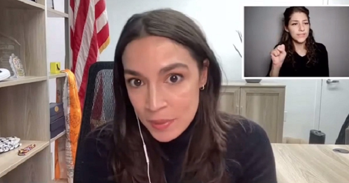 Rep. Alexandria Ocasio-Cortes is pictured in a virtual town-hall meeting on Monday. In the background is a sign language interpreter.