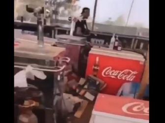 An Israeli man pictured walking through the concession area of a music festival attacked by Hamas terrorists on Oct. 7 in southern Israel.