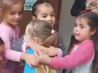 Emilia Aloni, center, was greeted with hugs from her kindergarten classmates on her first day back in class after being held captive by Hamas terrorists for seven weeks.