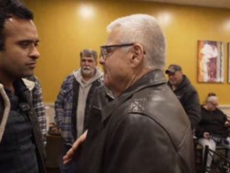 GOP presidential candidate Vivek Ramaswamy (left) speaks with Mike Wyatt, who identified himself as a former FBI agent and warned Ramaswamy to be "very careful" after the candidate called for the FBI to be shut down, and its duties transferred to other agencies in the federal government.