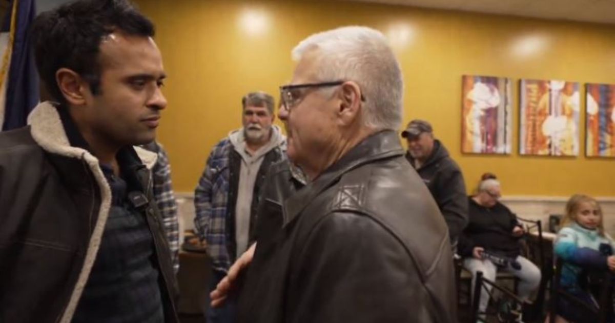 GOP presidential candidate Vivek Ramaswamy (left) speaks with Mike Wyatt, who identified himself as a former FBI agent and warned Ramaswamy to be "very careful" after the candidate called for the FBI to be shut down, and its duties transferred to other agencies in the federal government.