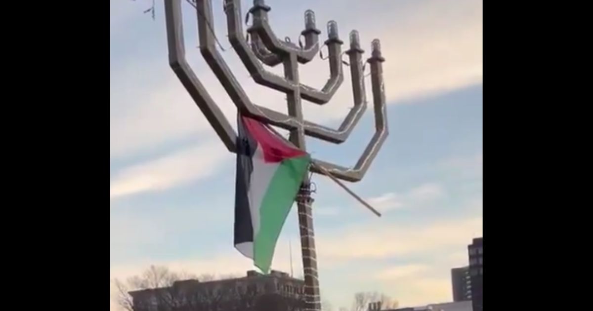 A Palestinian flag is seen on top of a menorah at Yale University.