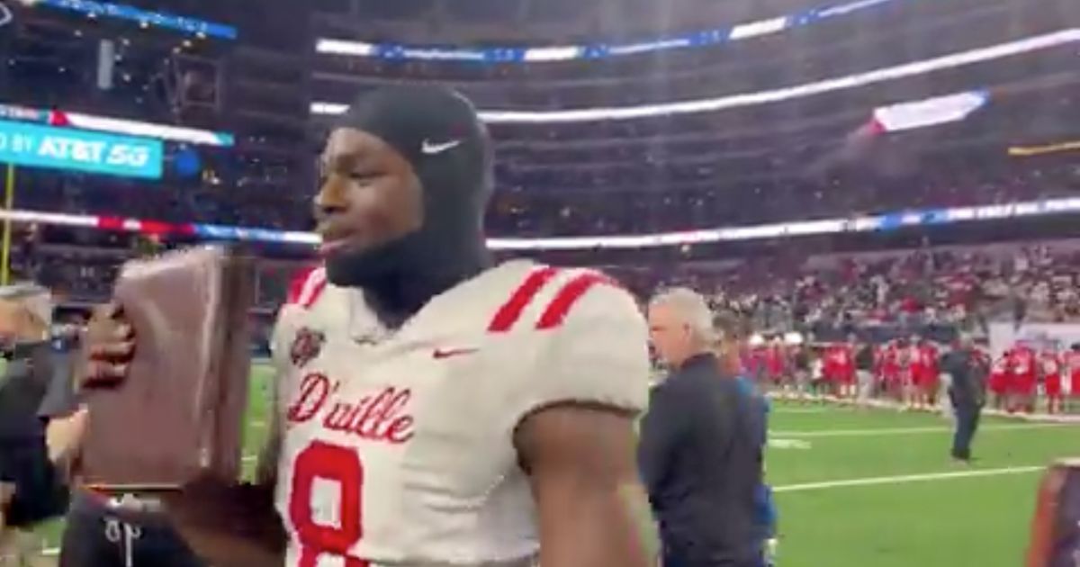 Five-star high school football prospect Colin Simmons is seen with a Bible.