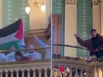 One protester waves a Palestinian flag, left, as another screamed slogans from the gallery.