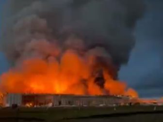 Fire engulfs buildings at a chicken farm in Kurten, Texas, on Monday.