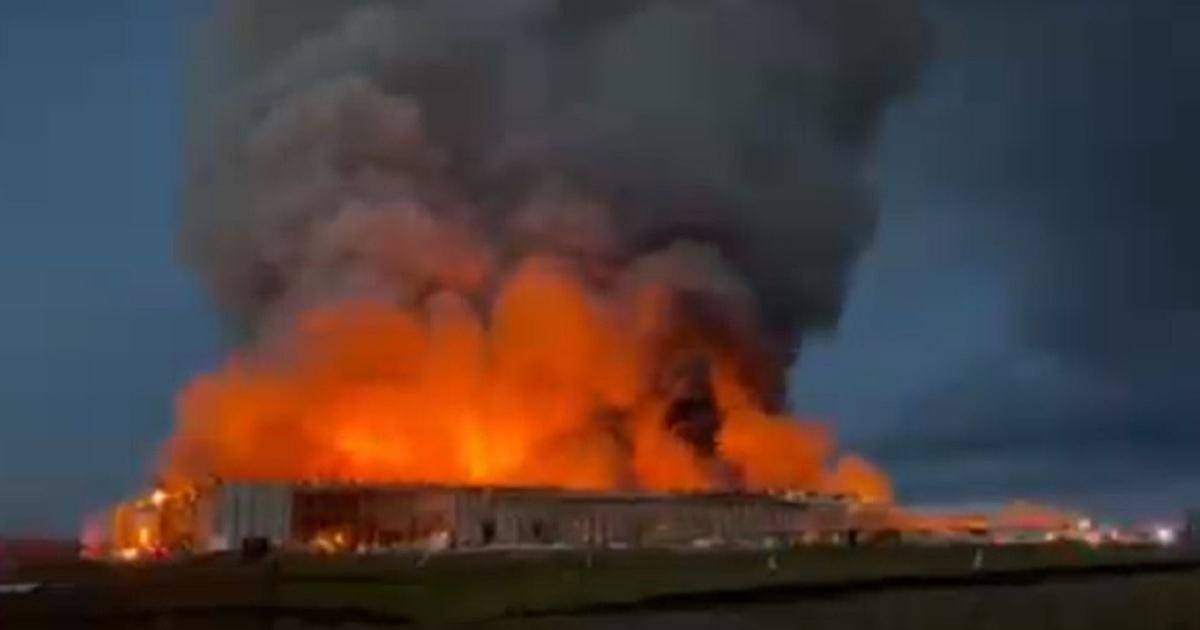 Fire engulfs buildings at a chicken farm in Kurten, Texas, on Monday.