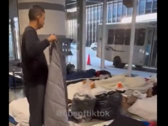 A migrant adjusts bedding at Chicago's O'Hare Airport.