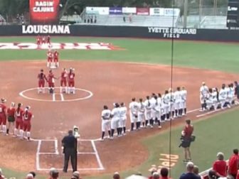 Softball players from the University of California, Berkeley, kneel during the national anthem prior to a Feb. 9 game at the University of Louisiana, Lafayette.