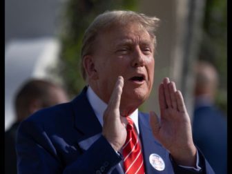 Former U.S. President Donald Trump speaks to the media Tuesday after voting at a polling station in Palm Beach, Florida.