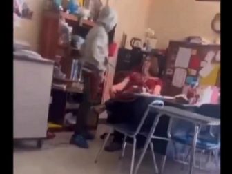 A student hovers over a teacher before delivering a second slap in a classroom confrontation on April 15 in Winston-Salem, North Carolina.