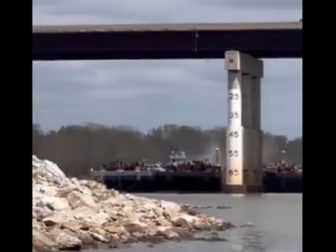 A barge strikes a bridge across the Arkansas River Saturday near Sallislaw, Oklahoma.